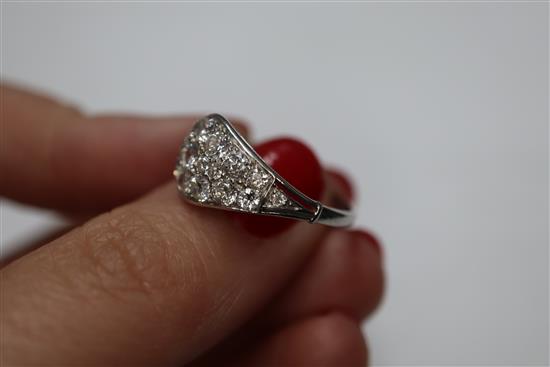 A white metal and diamond cluster set elliptical shaped ring, size H/I.
